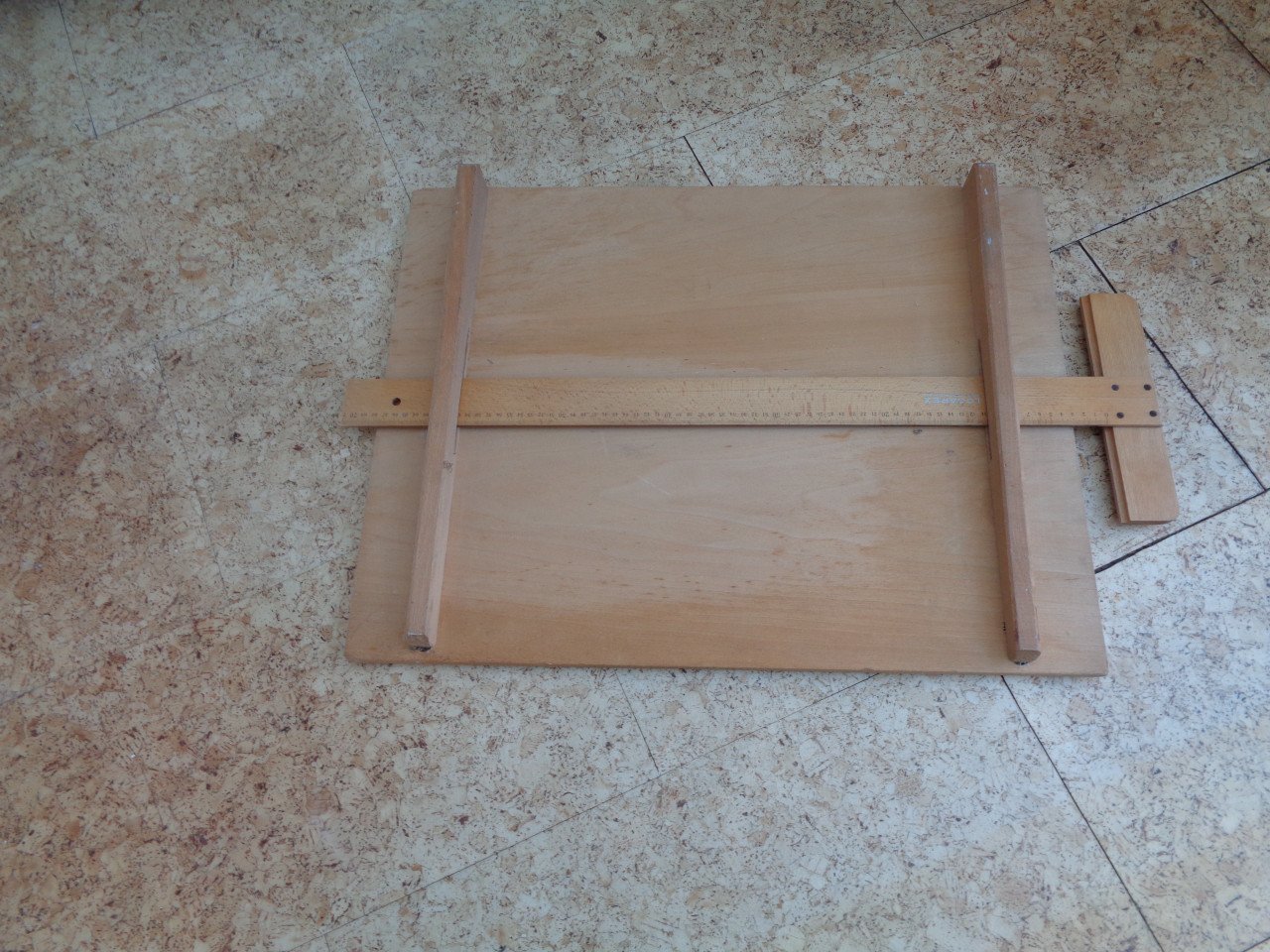 Houten tekenblad met bijbehorende tekenhaak.