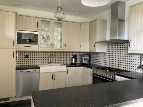 Keuken in U-vorm met 6-pitsgasfornuis, afzuigkap, koelkast en magnetron