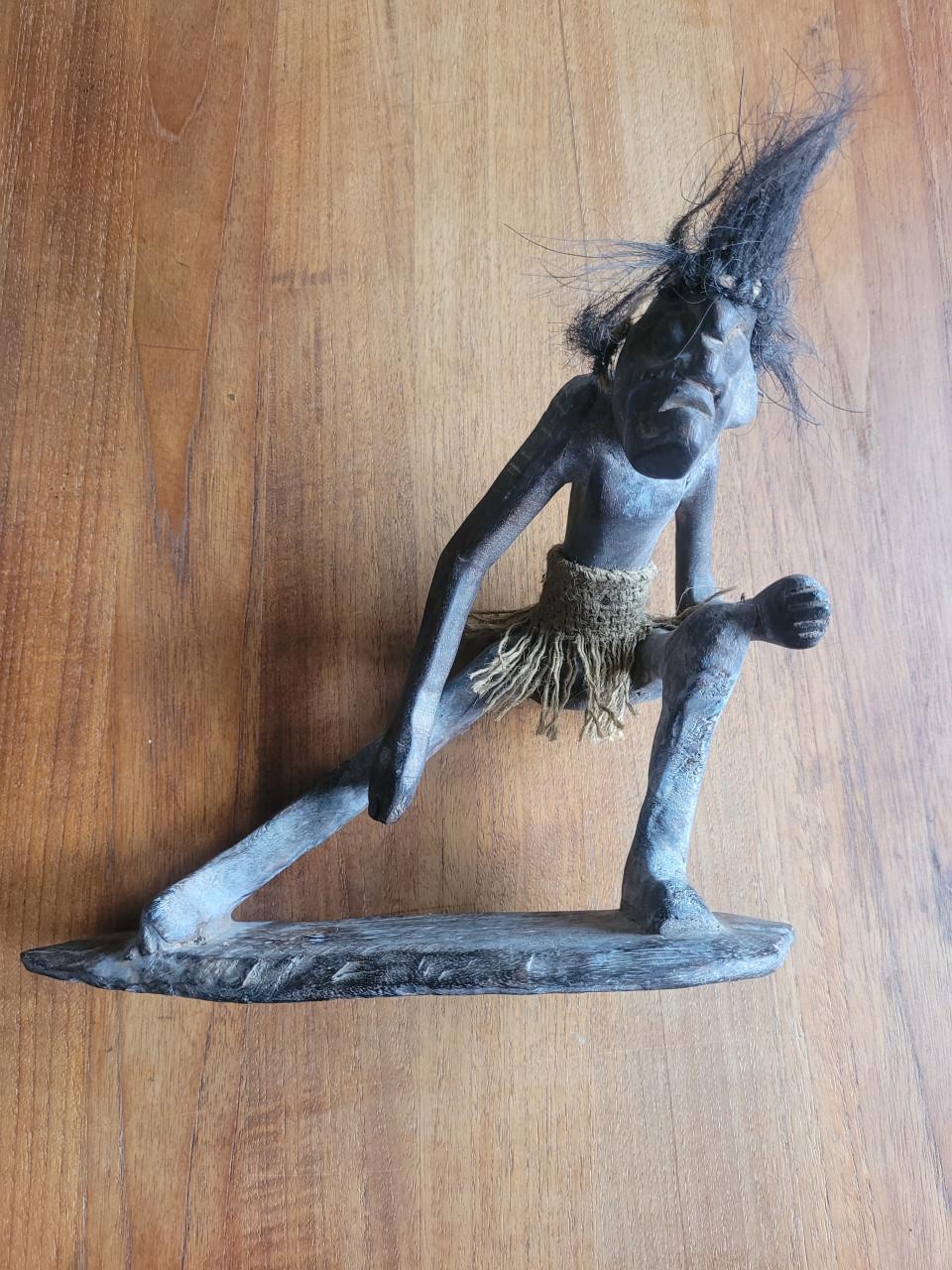 Houtsnijwerk uit Indonesië, stoere man op surfboard