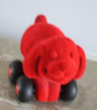 Rood stoffen hondje op wielen