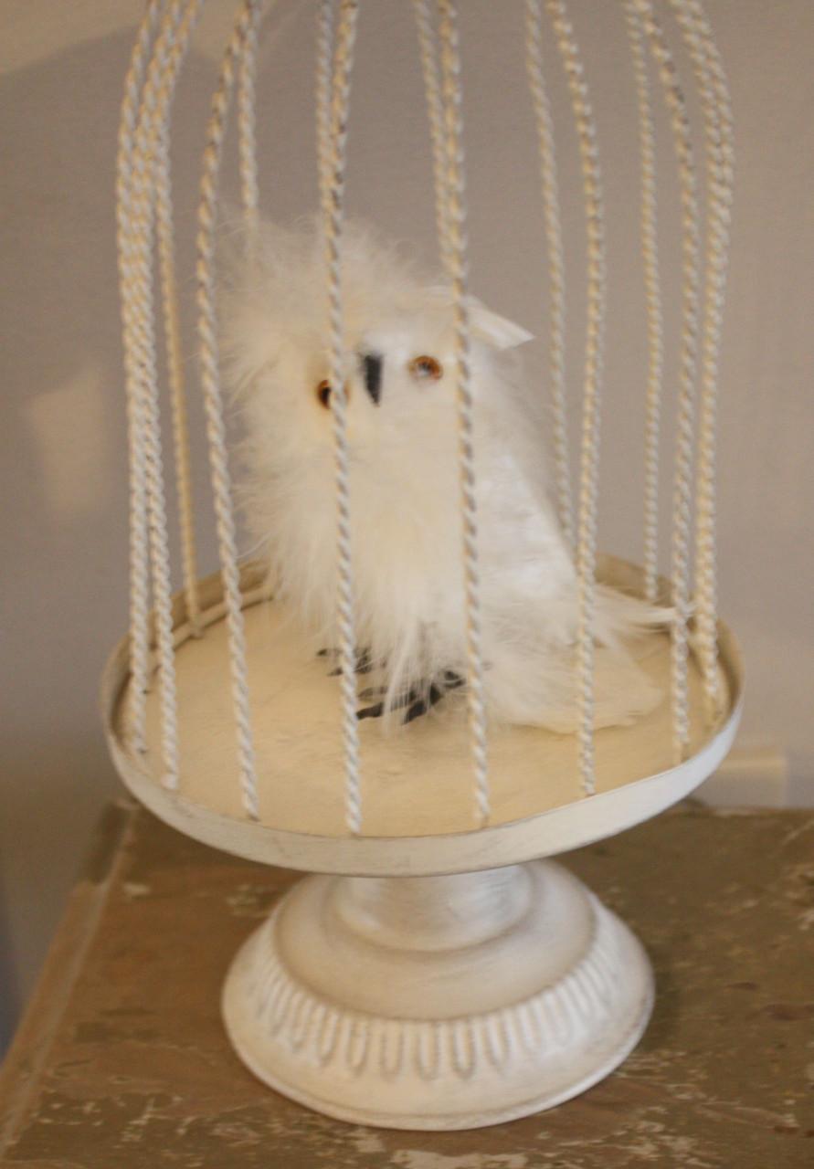 Wit metalen vogelhuisje met vogel