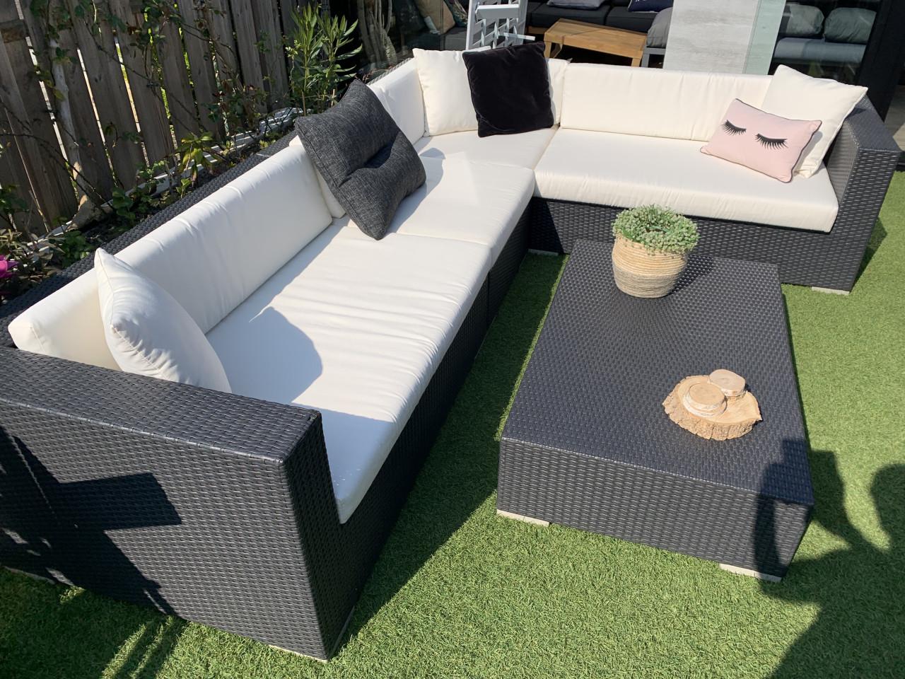 Wicker loungeset zwart met kussens en tafel.