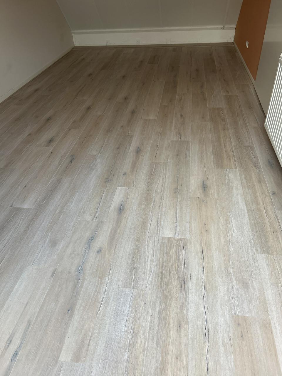 Laminaat licht met grijstinten v groef plinten en ondervloer