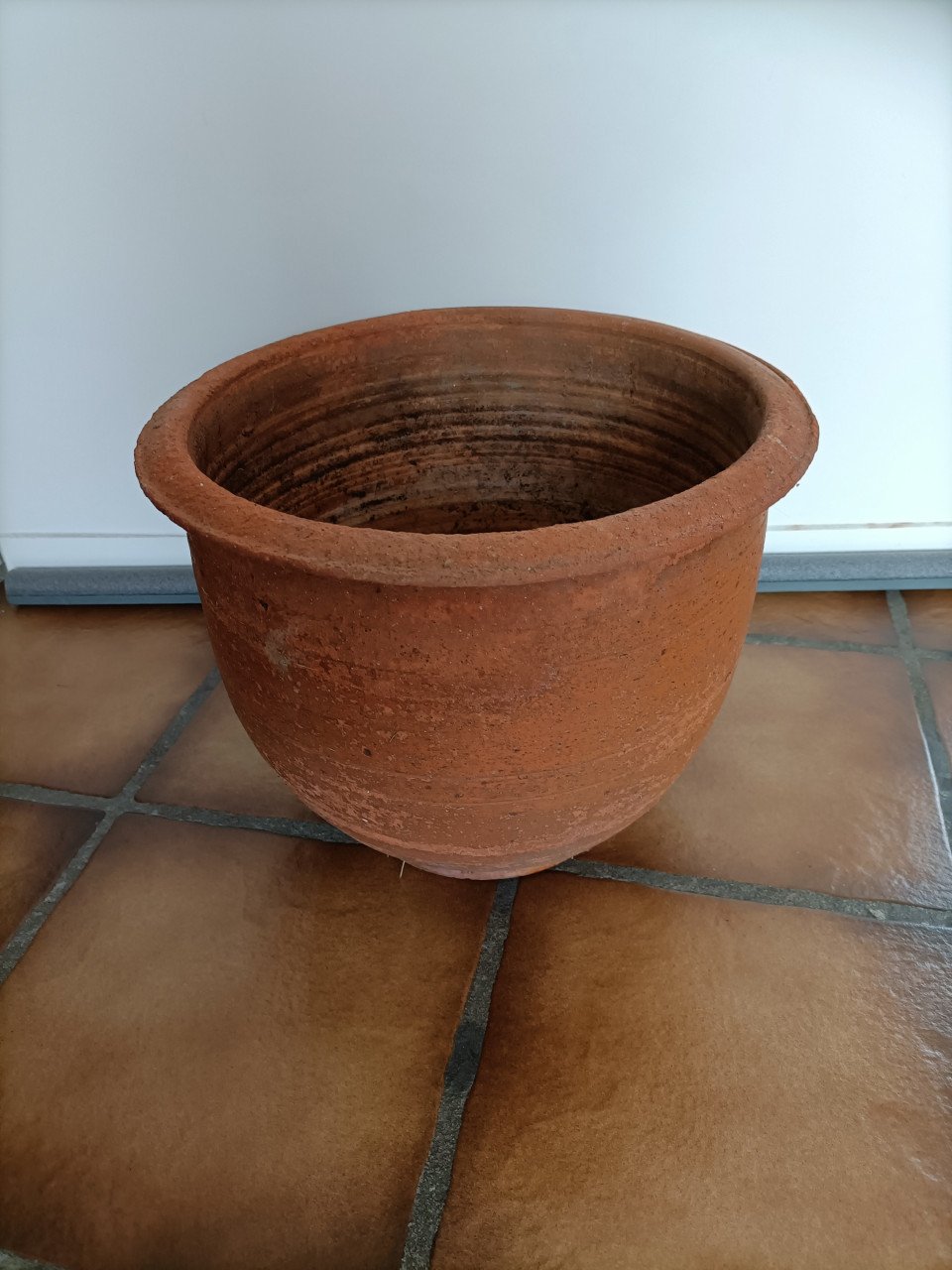 Terracotta buiten planten pot. In de bodem zit een gat voor de waterafvoer.