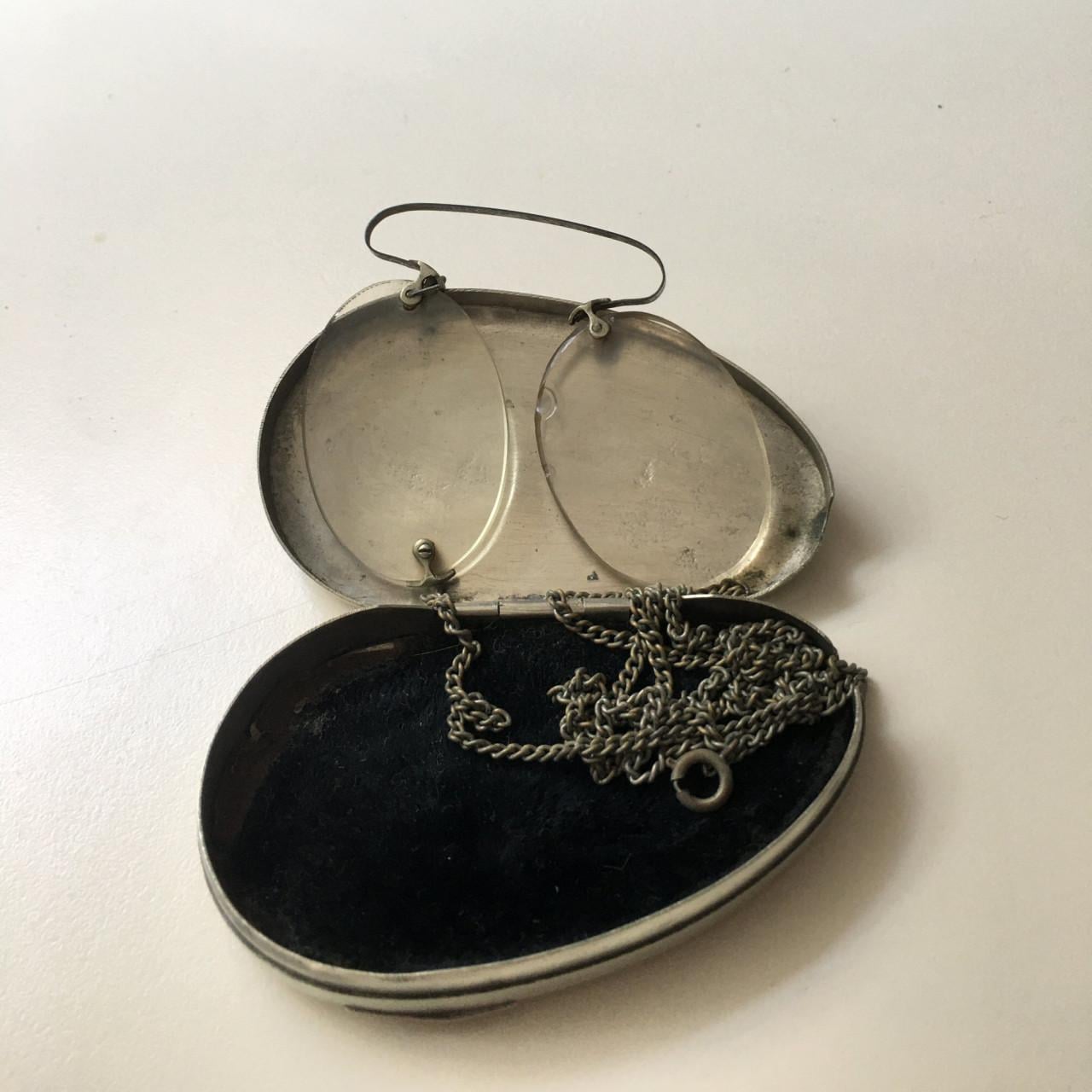 Een pince-nez in een zilveren doosje