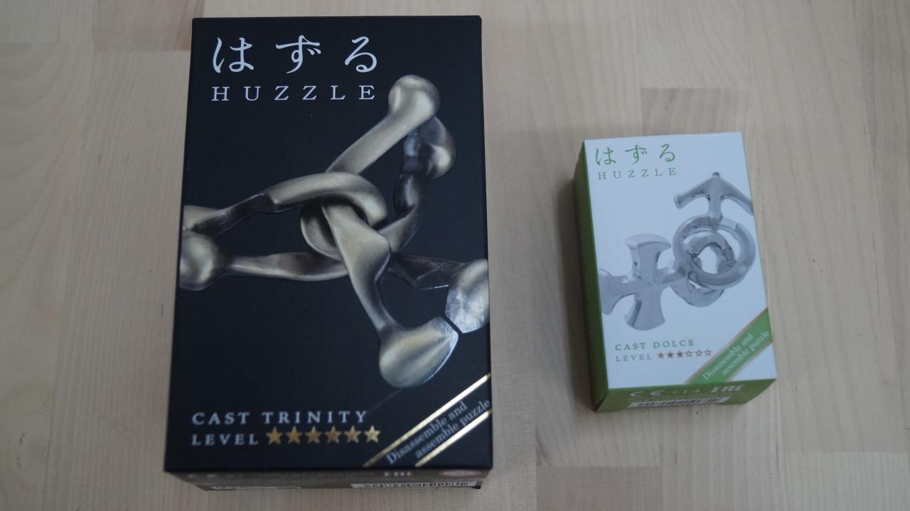 2x Huzzle puzzle, cast Trinity en cast Dolce