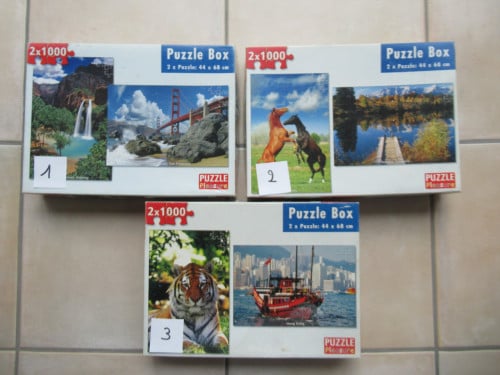 3 dozen met elk 2 leuke volledige puzzels van 1000 stukjes, zgan