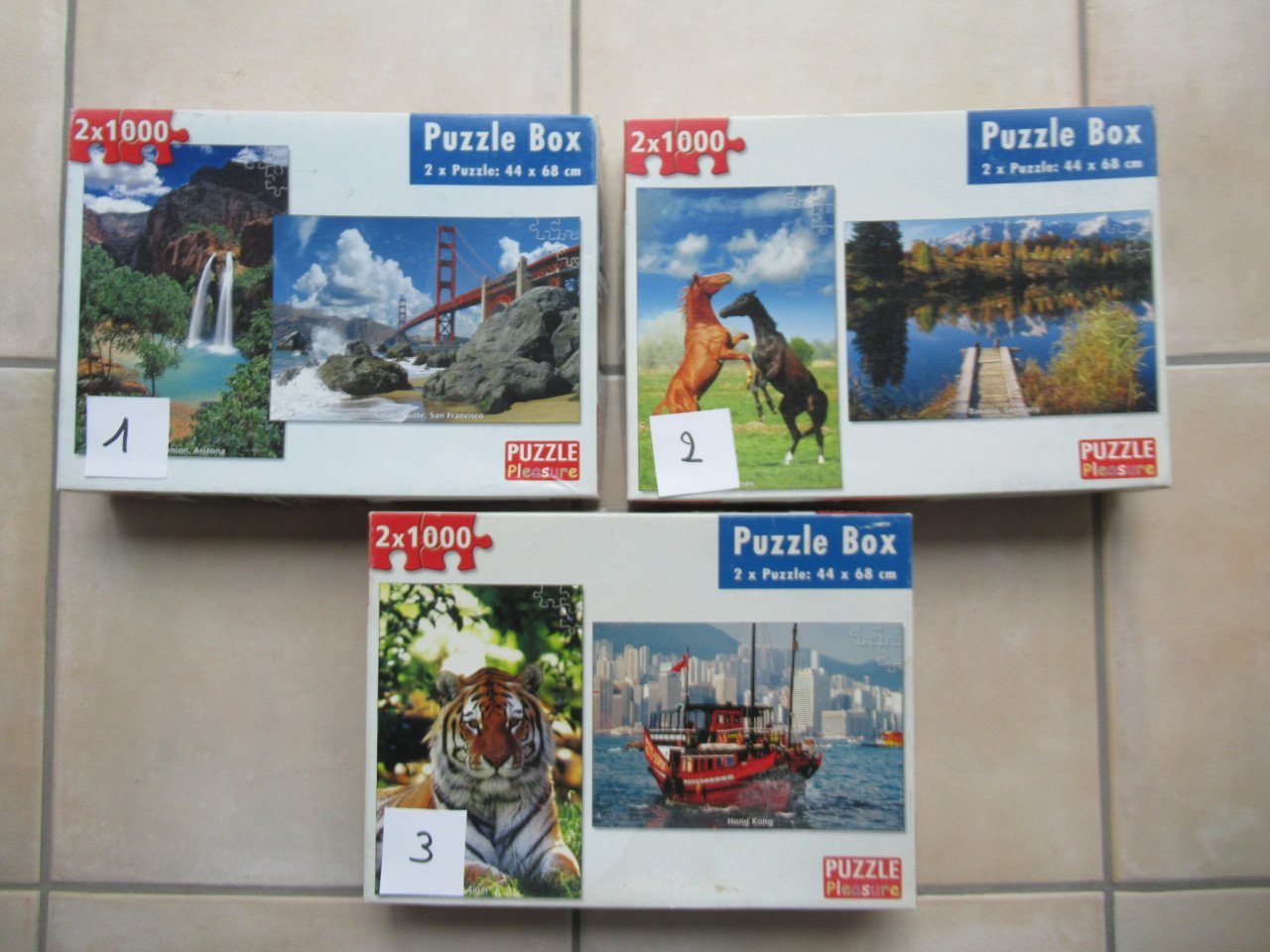 3 dozen met elk 2 leuke volledige puzzels van 1000 stukjes, zgan