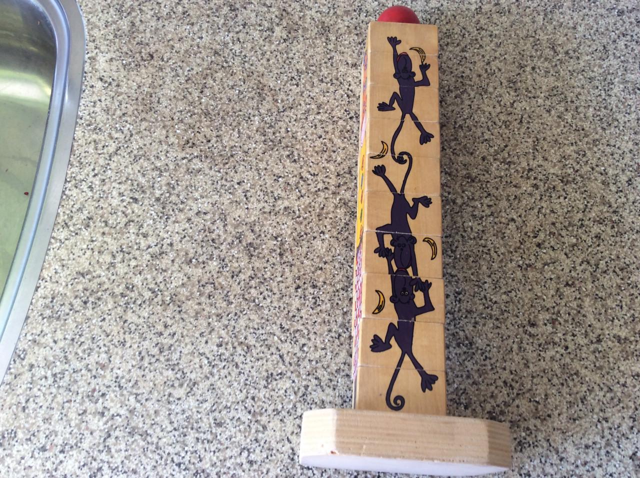 Stapeltoren, houten blokken en doos met blokken en knoppuzzels.