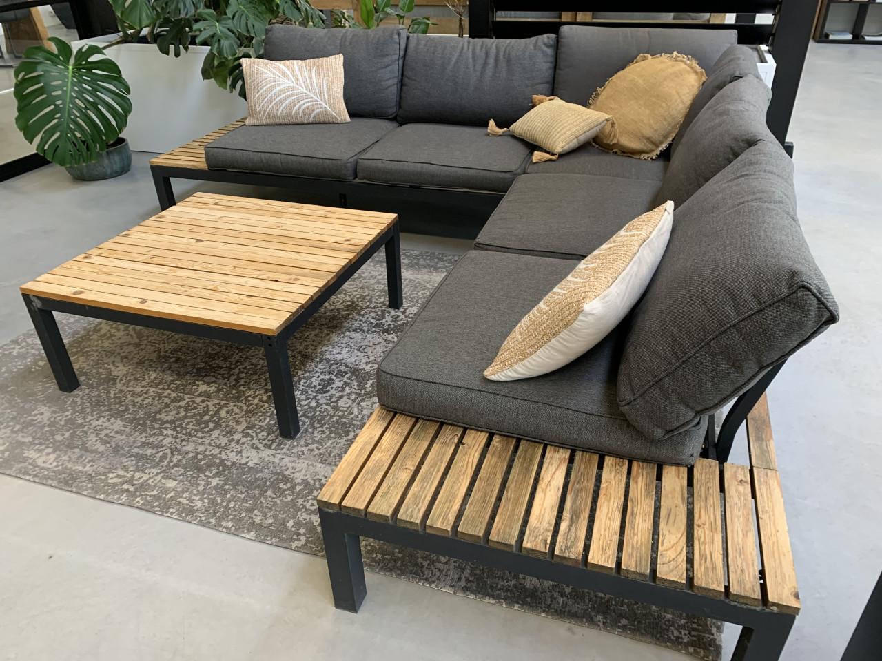 Zwart aluminium loungeset met houten plateaus, en tafel en kussens.