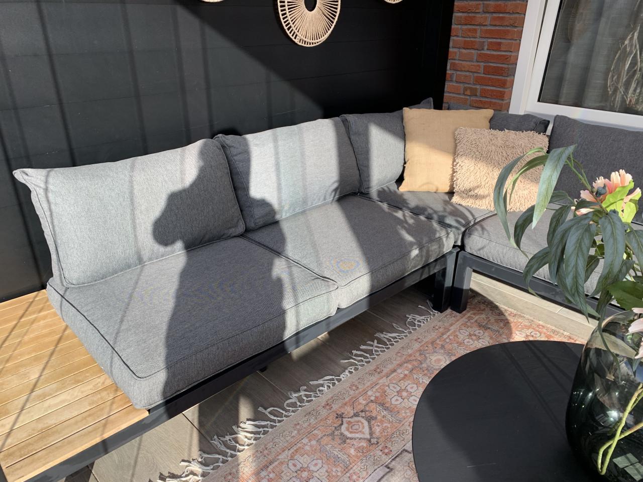 Zwarte loungset met houten plataus, kussens en tafel