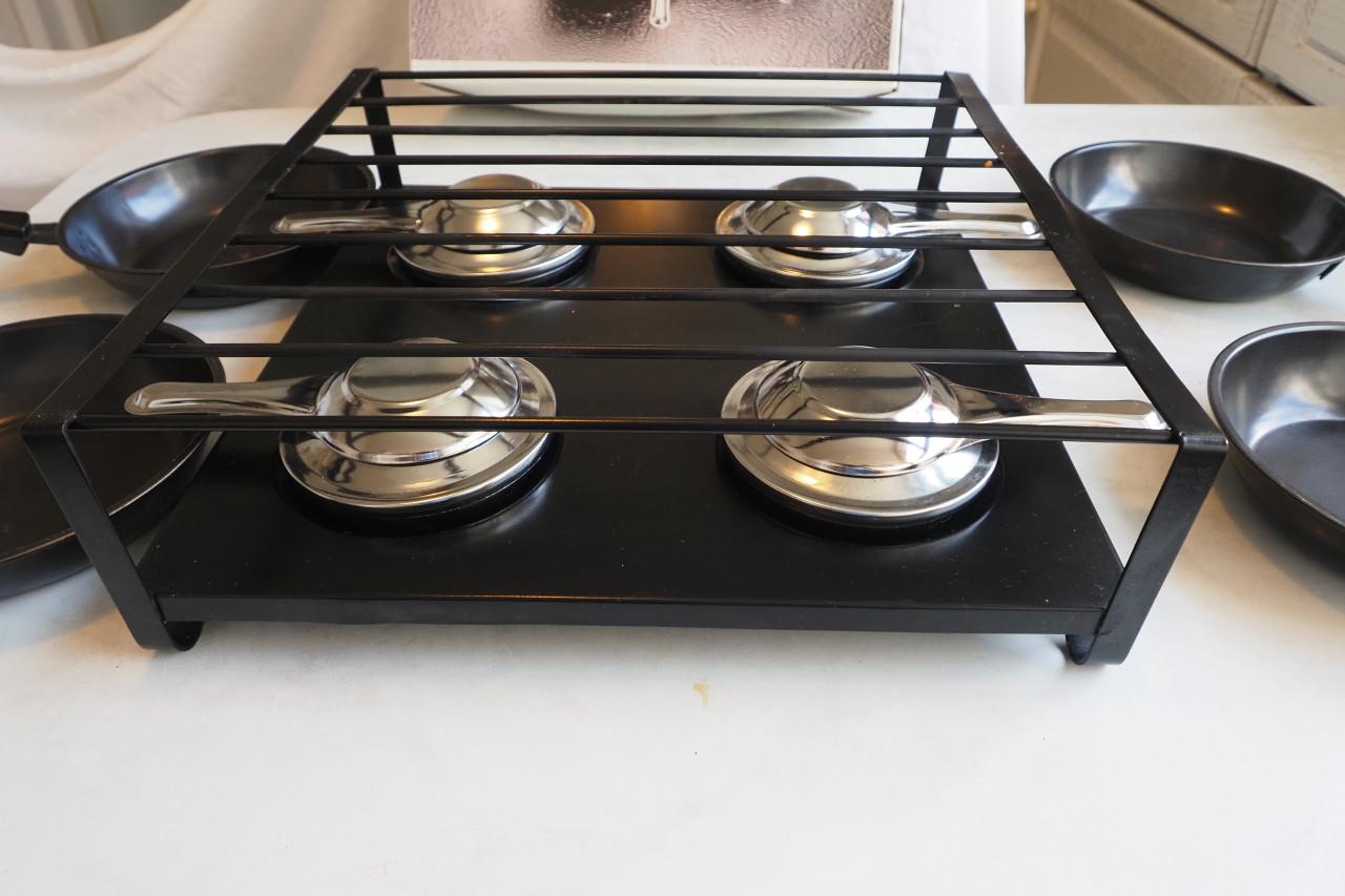 Gourmetstel, 1 x gebruikt. Met 4 zwarte pannetjes.