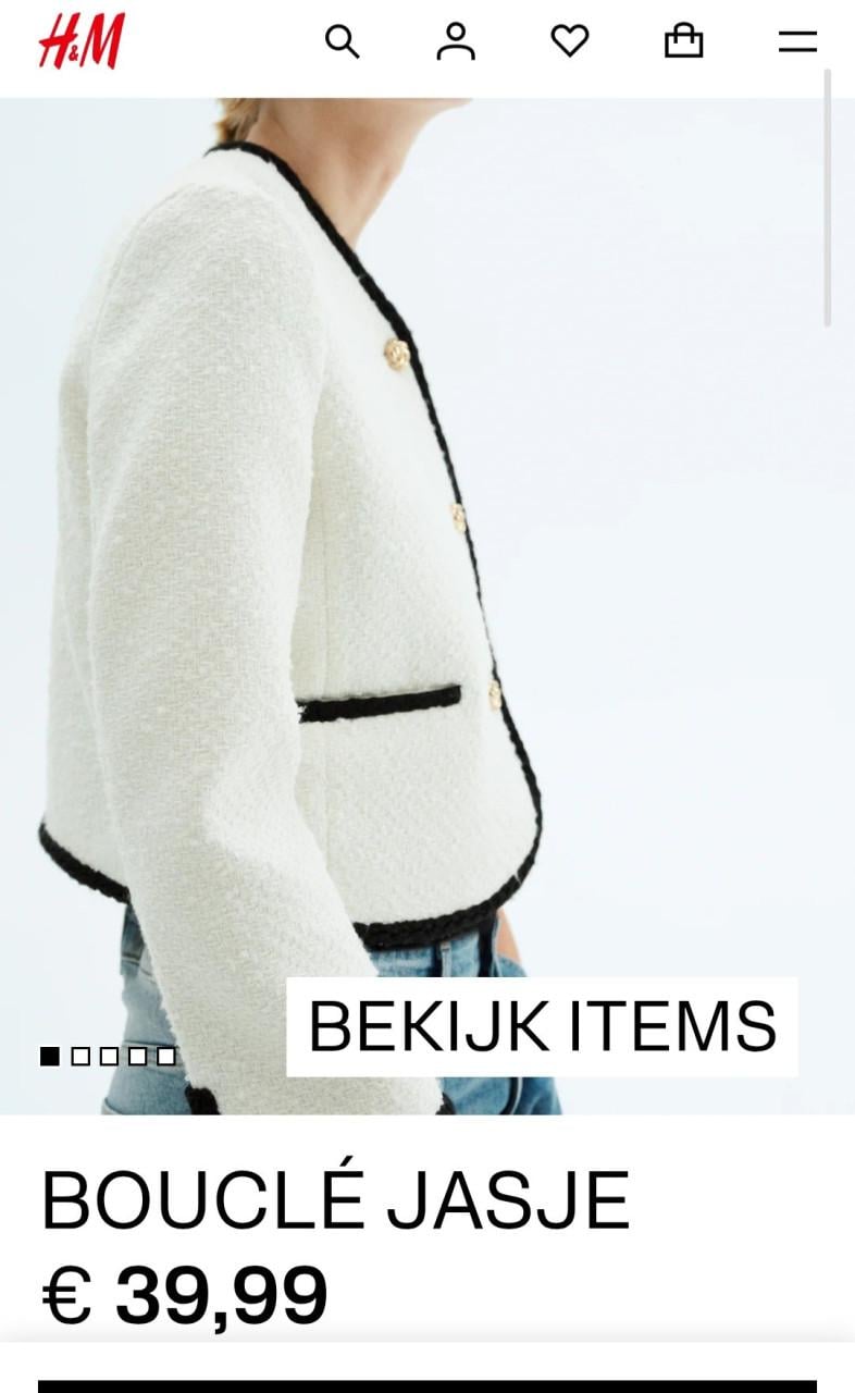 H&M bouclé jasje in de kleur room wit met zwarte bies. Maat 40