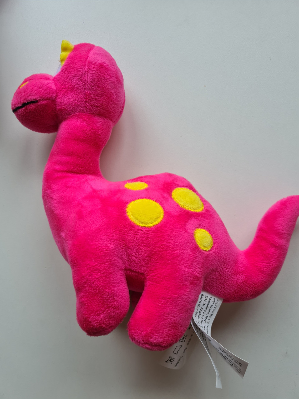 Schattige roze dinosaurus knuffel