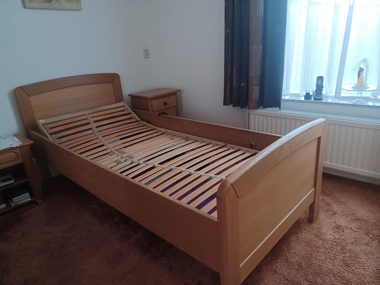 Senioren bed met electrische lattenbodem en nachtkastje