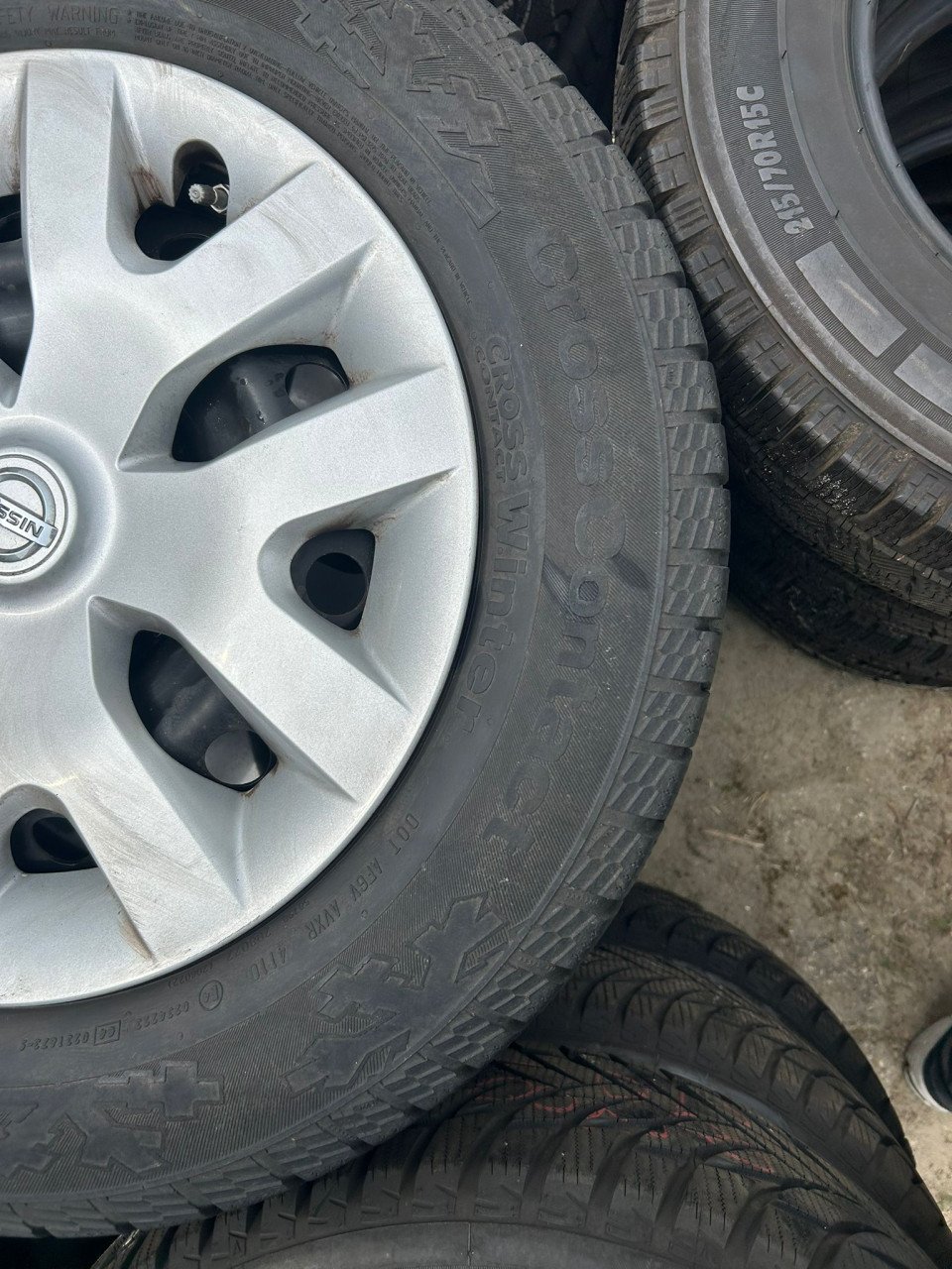 NISSAN STALEN VELGEN MET WIELDOPPEN EN CONTINENTAL CROSSCONTACT BANDEN '16'