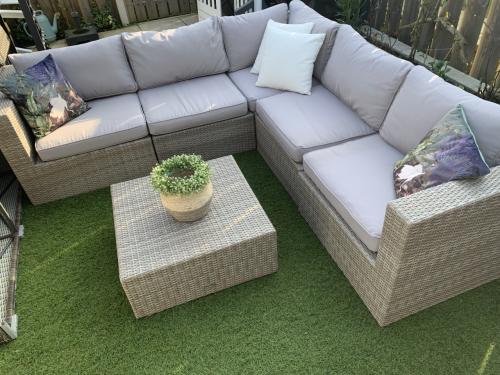 Loungset van pvc riet, met kussens en tafel.