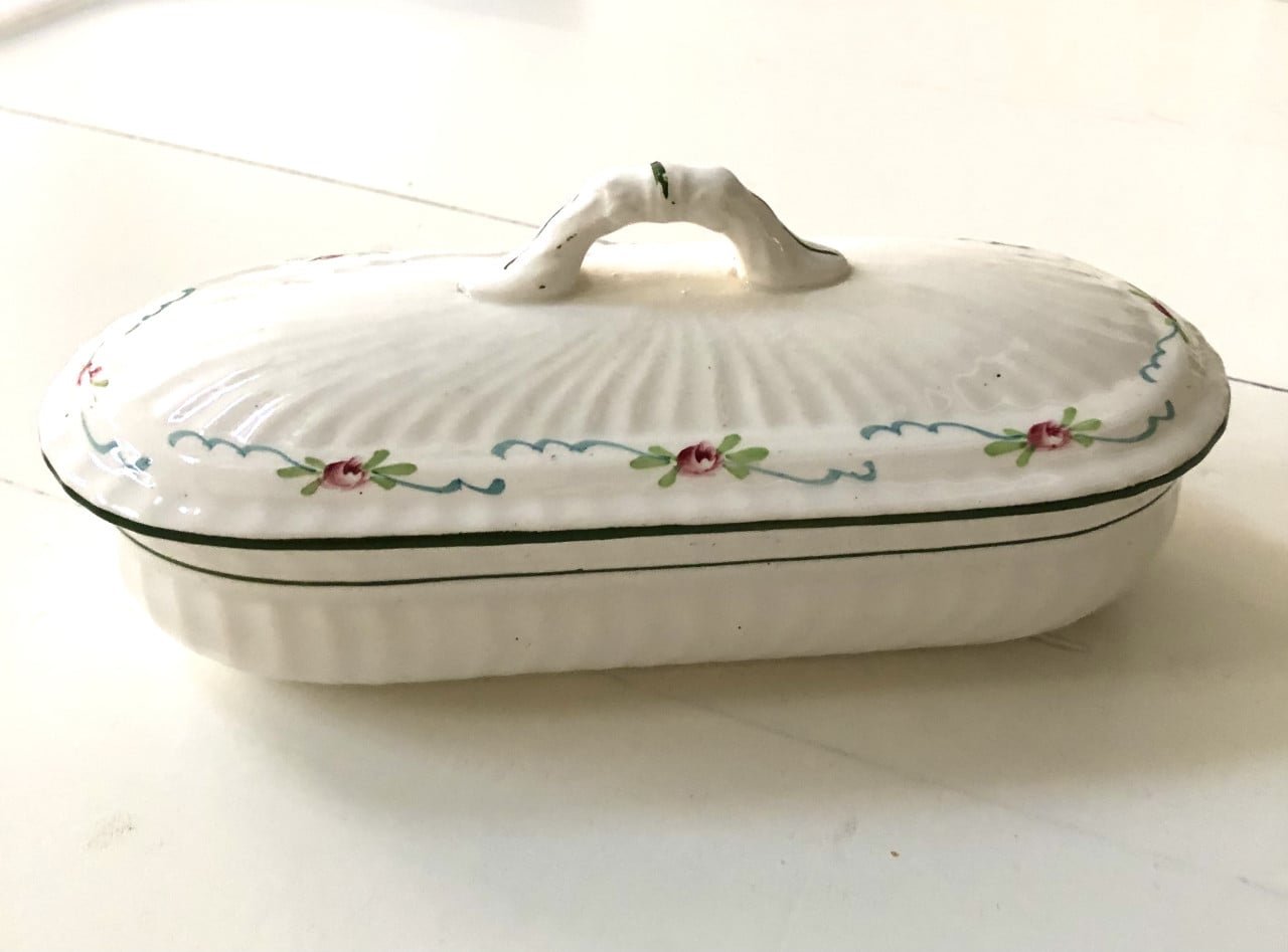 Lief brocante theelepelbakje van wit porselein met motiefje.