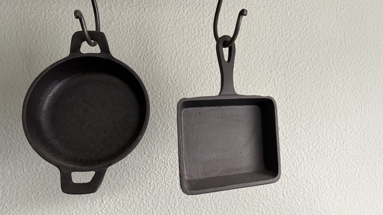 Metalen bakkersrek met gietijzeren pannetjes