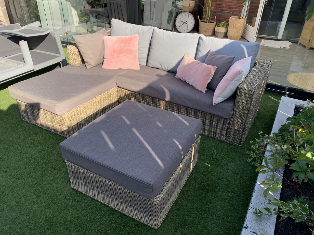 Rieten loungeset, met kussens en tafel.