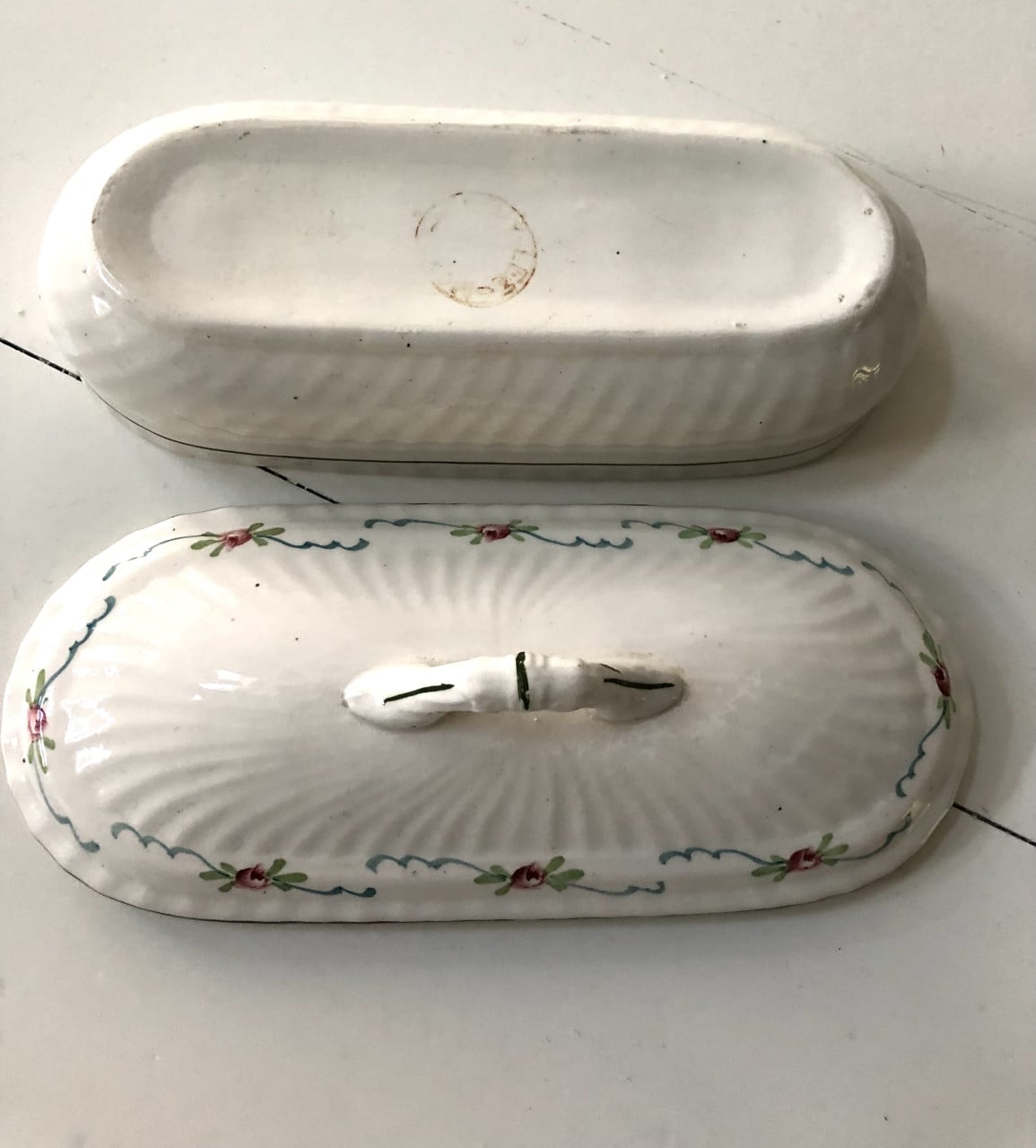 Lief brocante theelepelbakje van wit porselein met motiefje.