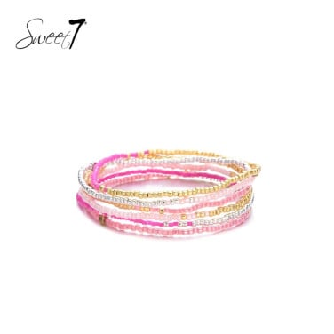 Roze gekleurde armbanden van glas kralen