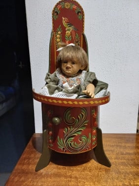 Oud kakstoeltje met pop