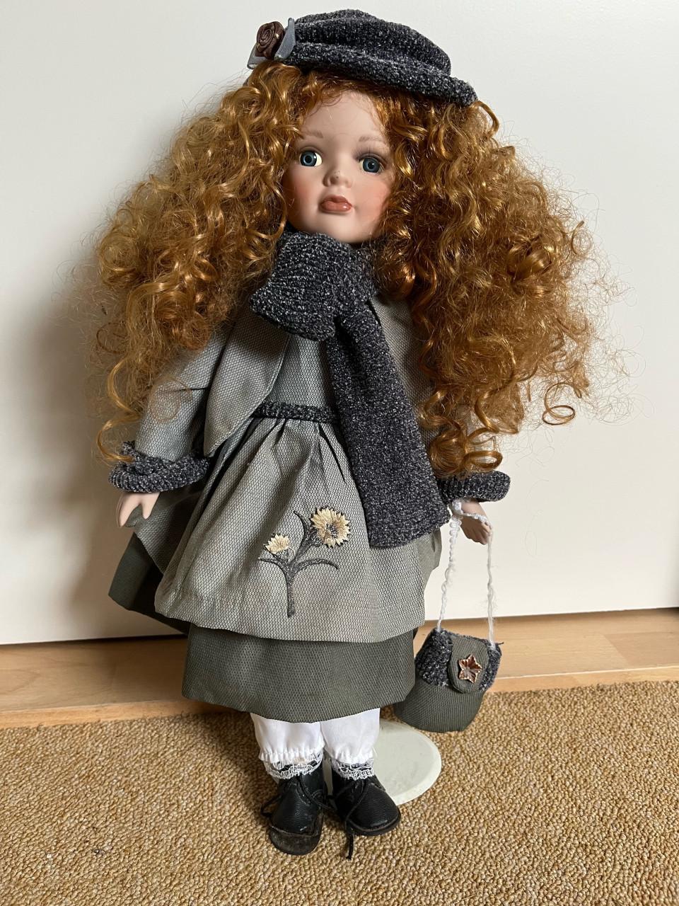 Pop op standaard met porseleinen hoofdje 45cm.