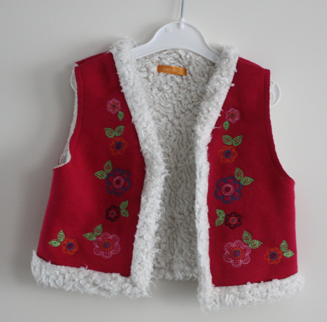 Roze bodywarmer met borduursel maat 86-92