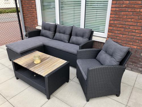 Lounge tuinset (hoekbank, stoel en tafel) van kunststof + houten loungebank