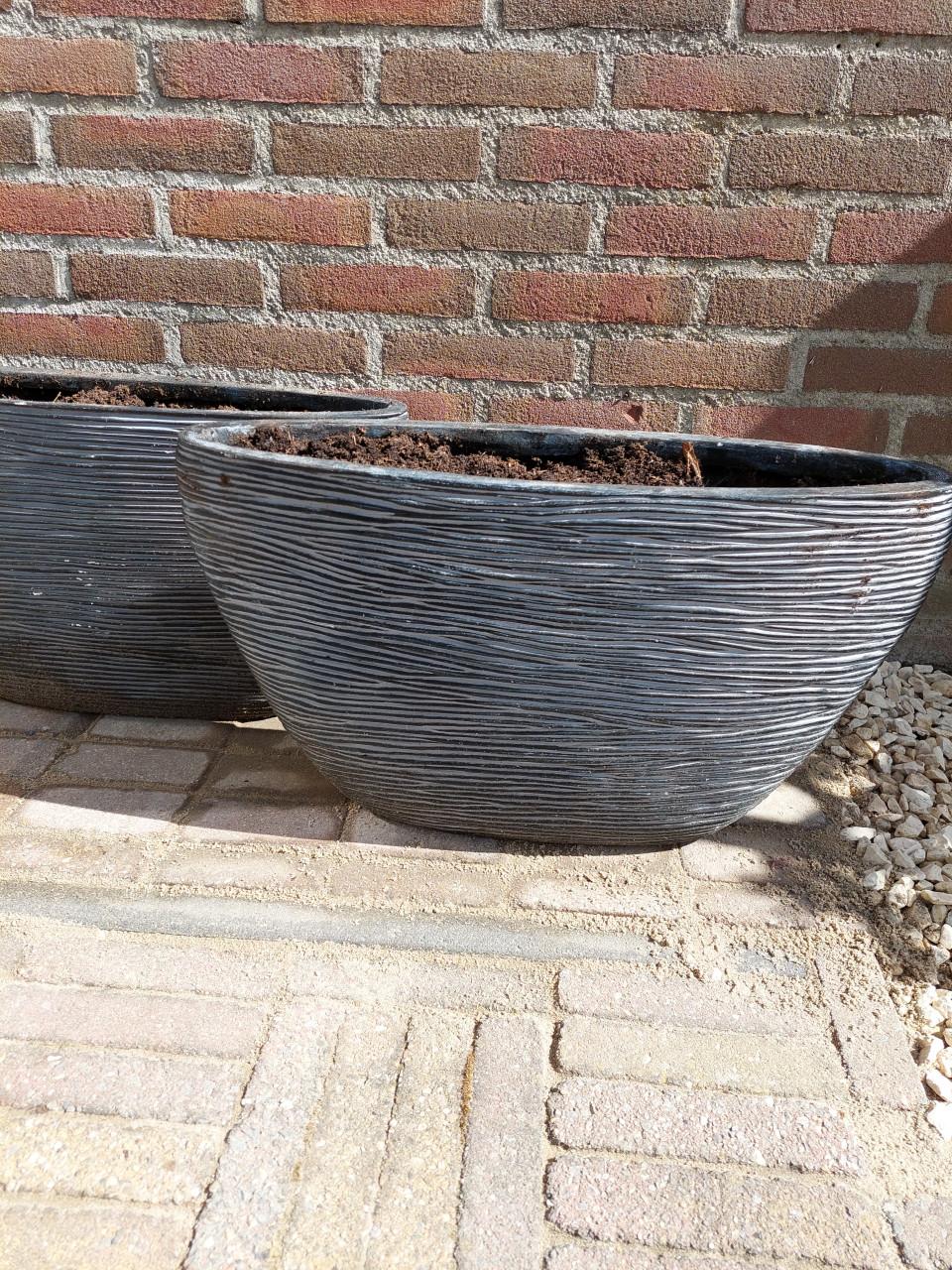 2 zwart/antraciet stenen plantenbakken in goede staat