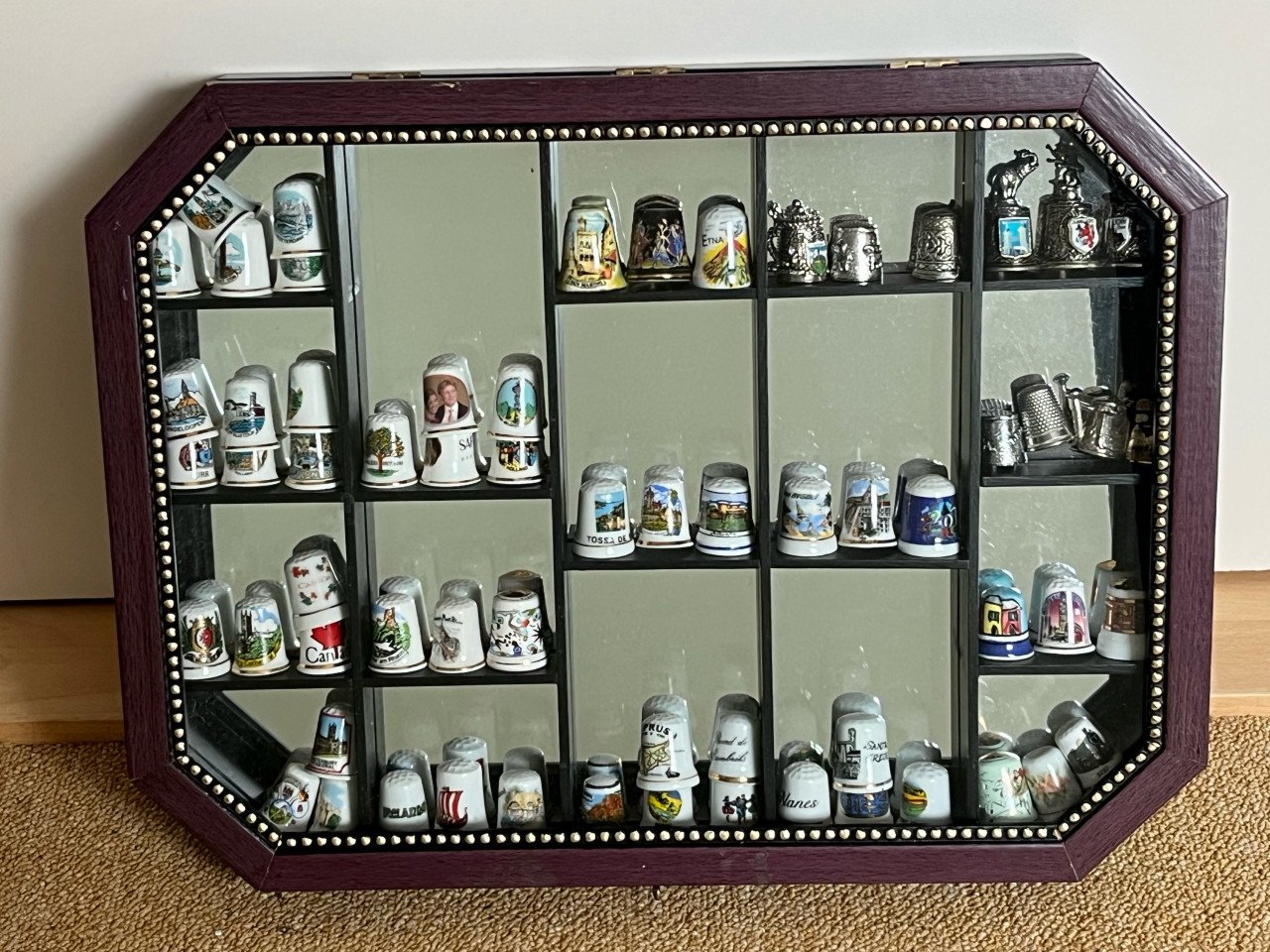 Vitrinekastje met verzameling vingerhoedjes