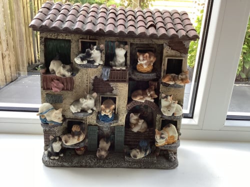 Stenen kattenluik met katten beeldjes