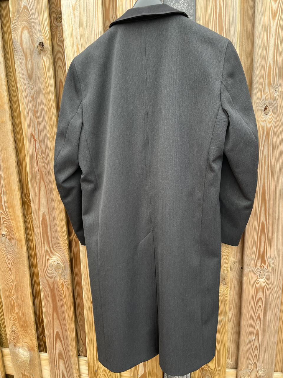 Grijze heren jas met zwarte kraag.