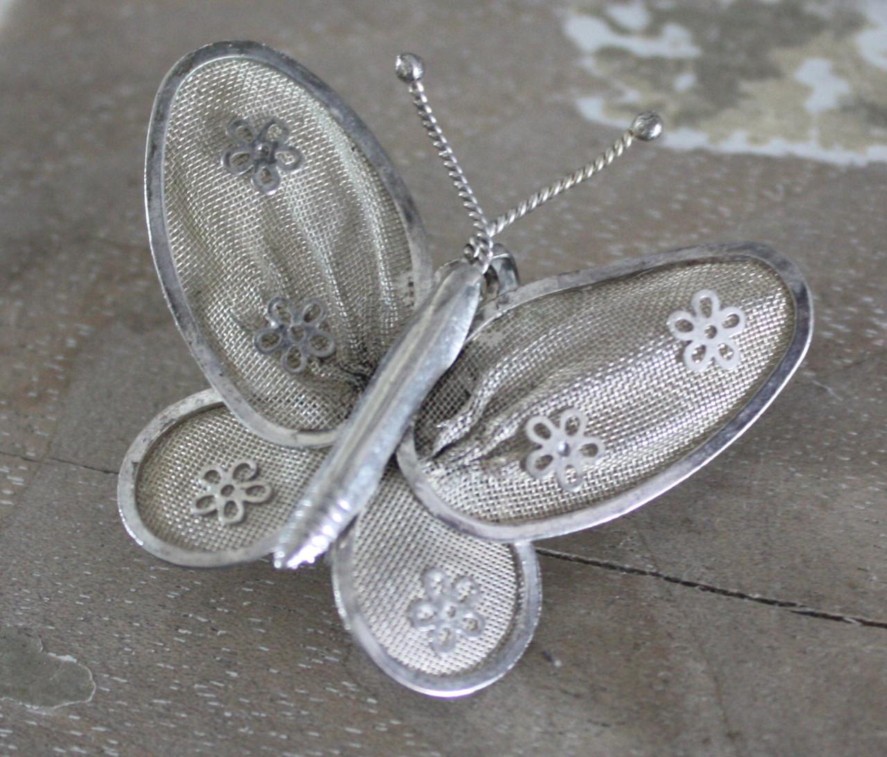 Zilverkleurige broche en hanger in 1 vlinder