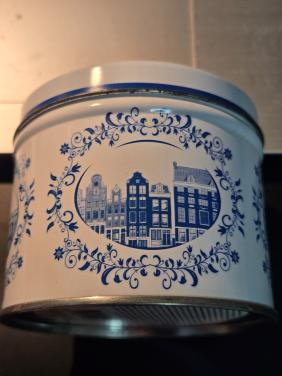 Delfts blauw stroopwafelblik met Amsterdamse grachtenpandjes.