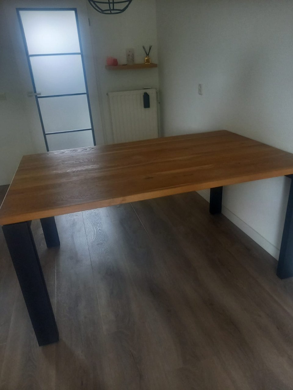 Mooie eettafel met massief teakhouten blad en zwart metalen poten