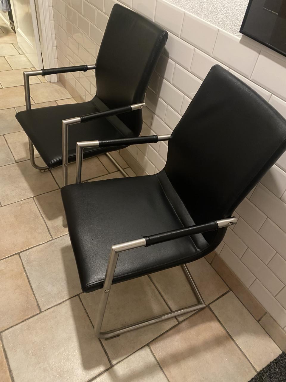 Twee zwarte leren stoelen