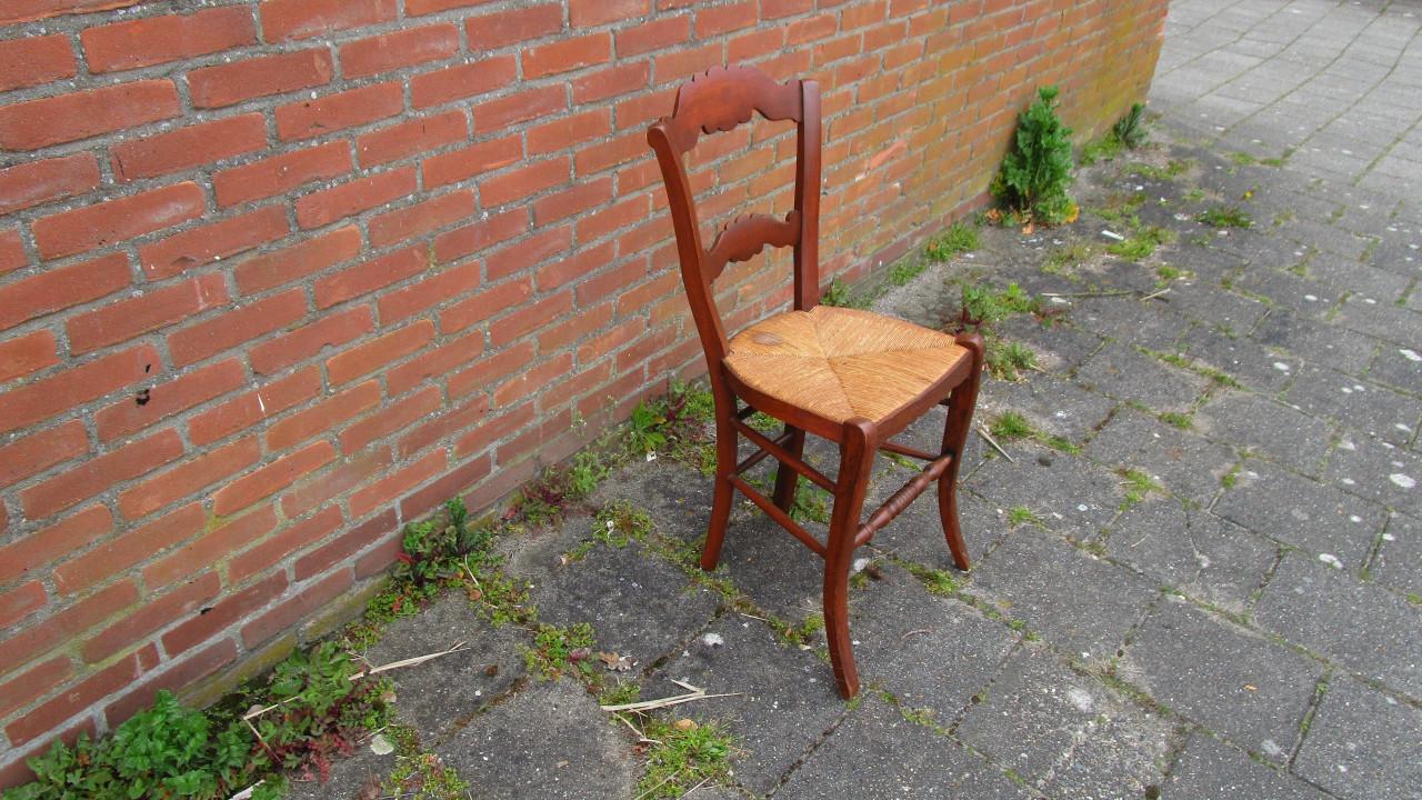 Antieke houten stoel met rieten zitting